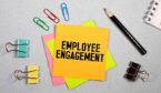 The words 'Employee Engagement' on a post it note with stationary around it