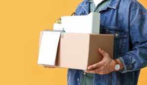 Person who quit holding a box of belongings