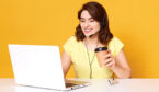 Person sat at their desk with a computer and coffee with a yellow background.