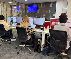 Image from Costa site visit showing agents working at their desks