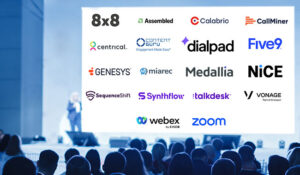 Speaker giving a talk in conference hall at business event with company logos on board