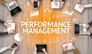 Group of Busy People Working in an Office with the word 'Performance management' in the middle.