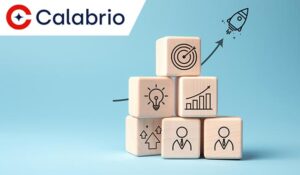 Stack of wooden blocks with different performance management icons on