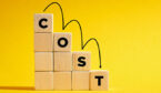 The word Cost on descending step stairs of wooden cubes.