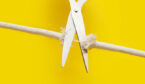 Scissors with frayed rope - cutting tension concept
