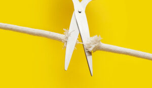 Scissors with frayed rope - cutting tension concept