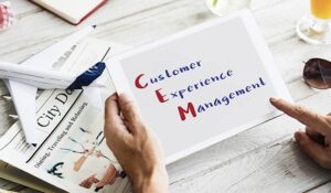 The word 'Customer Experience Management' on a tablet