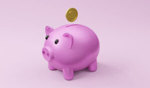 Piggy bank with a coin going in