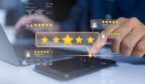 Person with laptop and mobile with high ratings on top