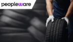 Lots of tyres with someone holding one
