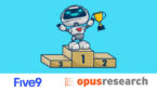 Robot stood on the top of a podium holding a trophy