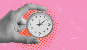 Person holding a tiny clock