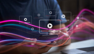 Person with phone and video screens