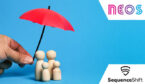 Family of wooden blocks with a red umbrella over the top shielding them