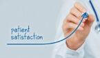 Person drawing a arrow that goes up with the word patient satisfaction on it