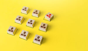 A group of blocks with people icons with one off centre and red