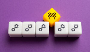 Broken process concept with cogs on blocks and a barrier above