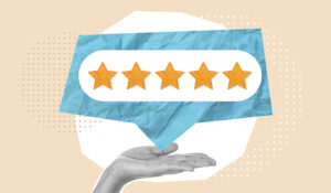 Hand holding a speech bubble with 5 stars in it