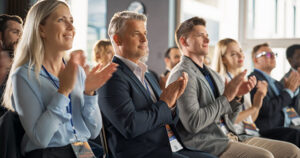 people at a conference clapping