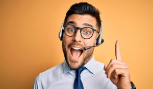 Man with a call centre headset in and holding up 1 finger