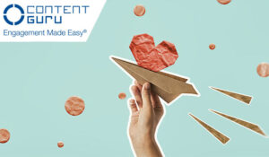 Person holding a paper aeroplane with a paper heart out the top