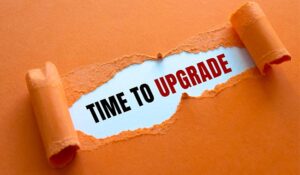 Orange paper that has been ripped and says 'Time to Upgrade' behind it