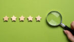 5 stars on a green background with a magnifying glass