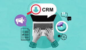 Hands on laptop keyboard with CRM and marketing icons like checklist, pie chart, gears, and chat bubbles in collage style on a textured blue background