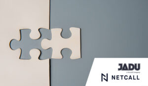 Two puzzle pieces connecting, one white and one grey, on a contrasting background