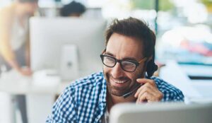 A worker in a headset sat at a desk