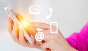 Person holding a phone with contact icons