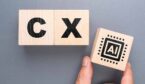 The word CX on blocks with someone placing another block with the word AI on it