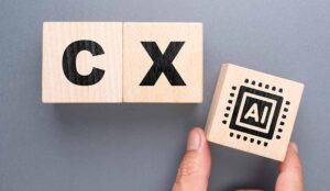 The word CX on blocks with someone placing another block with the word AI on it