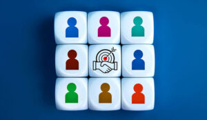 People icons on blocks surrounding one with a handshake and target