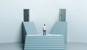 Man standing before two different staircases leading to separate open doors representing difference between two things