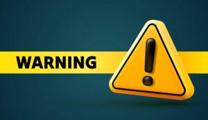 A warning sign with exclamation mark and WARNING text on yellow banner