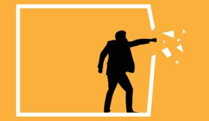 Break through concept with person breaking out of a box