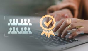 Close-up of hands typing on laptop keyboard with digital icons of certification, teamwork, checklist, and analysis - quality assurance concept