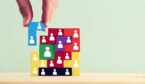 image of tangram puzzle blocks with people icons over wooden table - wfm concept