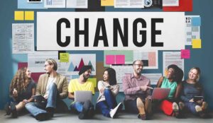 Change concept with a group of happy people sat below the word change