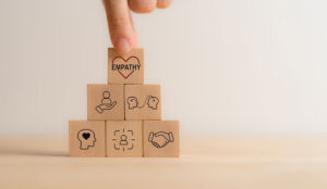 Empathy and empathy building concept with wooden blocks with empathy icons being built up