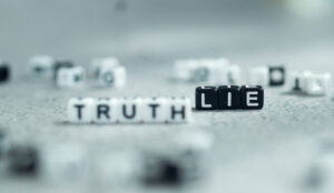 Lie vs. truth in white and black letter bead blocks